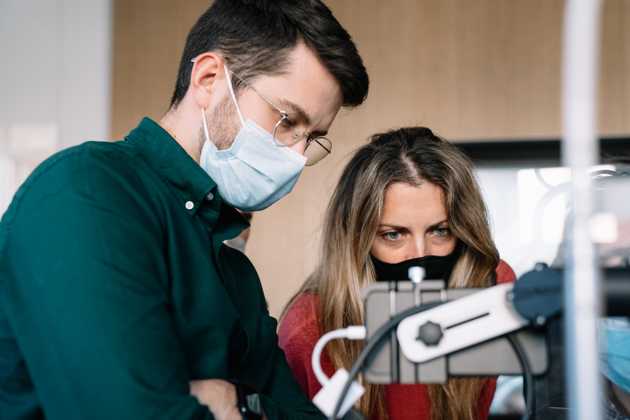woman and man looking a smartphone 